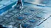 Close-up of Silicon Die are being Extracted from Semiconductor Wafer and Attached to Substrate by Pick and Place Machine. Computer Chip Manufacturing at Fab. Semiconductor Packaging Process.